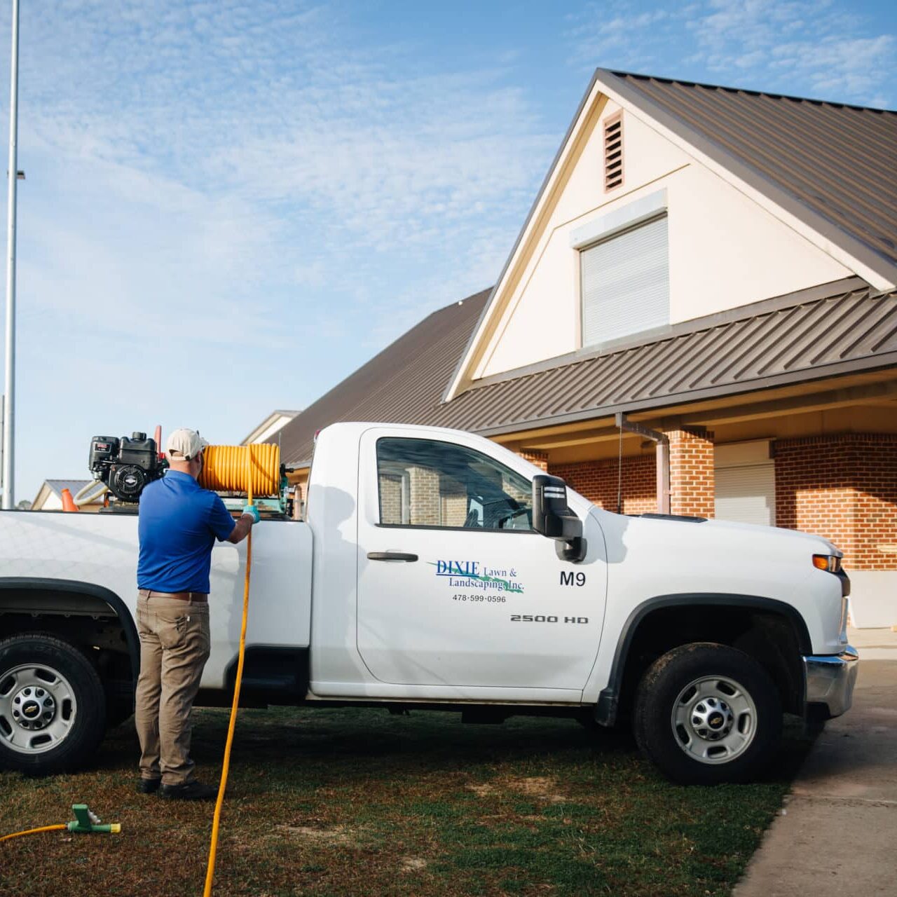 man getting cable from his work truck